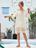 Apricot coloured hand-crocheted acrylic beach dress for women on a hanger.