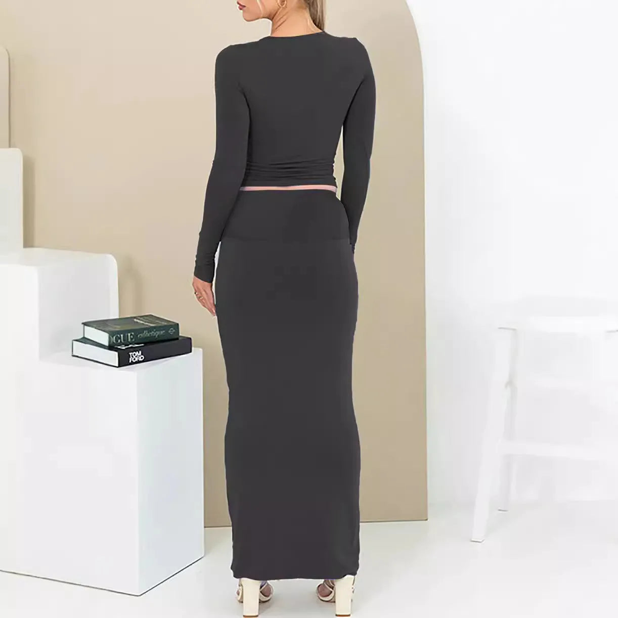 Women's autumn two-piece suit set in polyester, showing slim fit top with three-quarter sleeves and matching long skirt.