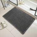 Checkered non-slip polyester bathroom floor carpet in a neutral colour on tiled floor.