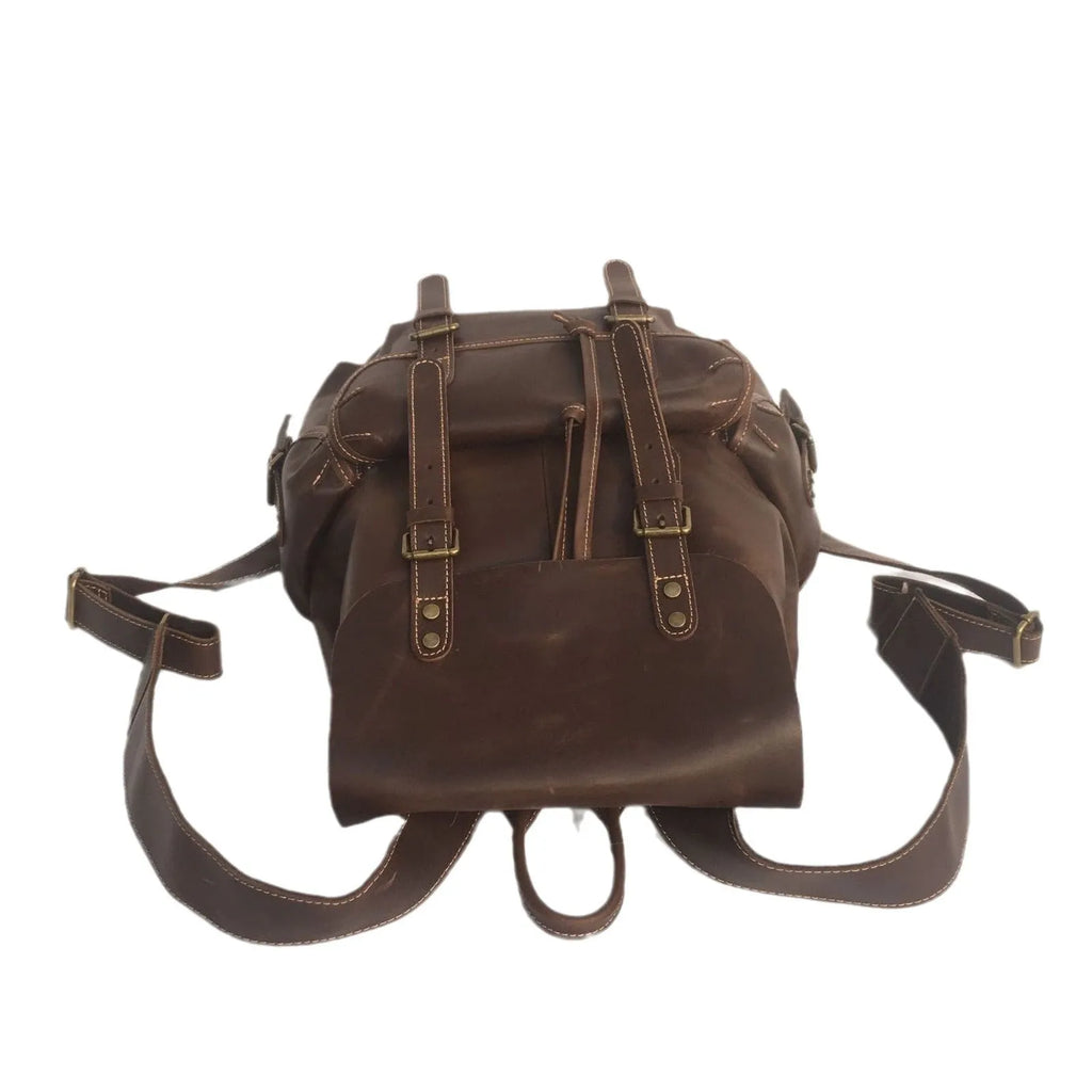 Brown men's leather backpack with an air-pillow belt system on the back.