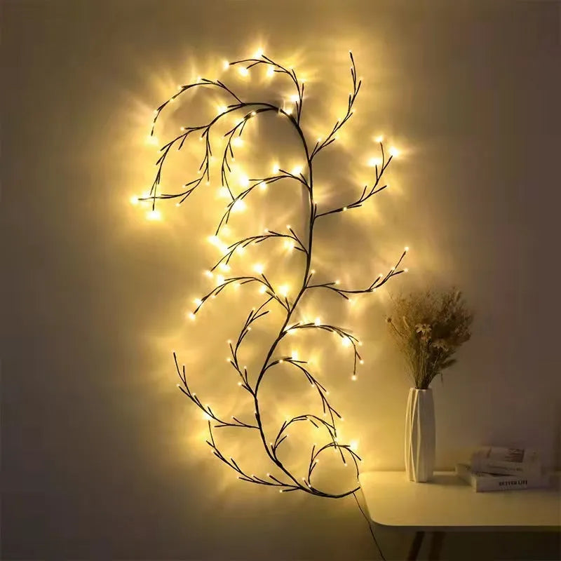 Flexible willow vine LED garland with warm white lights and white birch bark texture, bent into a decorative shape.