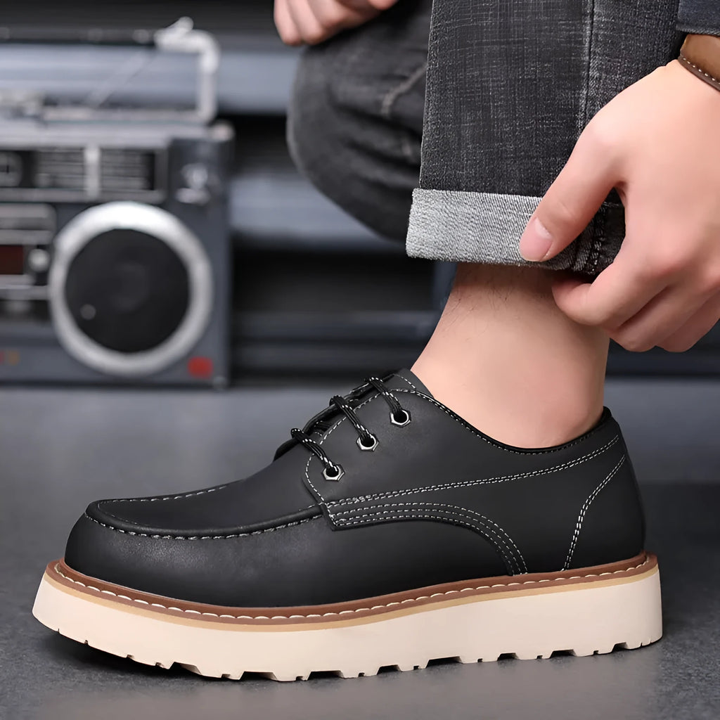 A pair of men's black retro-style low-top casual boots with a round toe and a rubber sole.