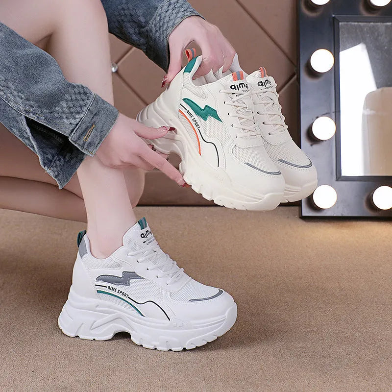 White women's lace-up dad shoes with cross straps and a breathable mesh upper.