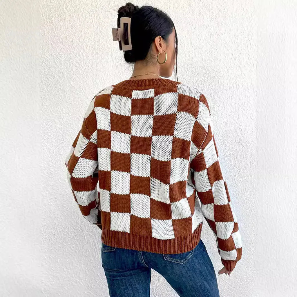 Dark brown plaid pattern on a loose round neck acrylic pullover sweater with long sleeves.