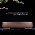 Large rectangular antique purple clay flower pot for indoor plants on a tabletop.