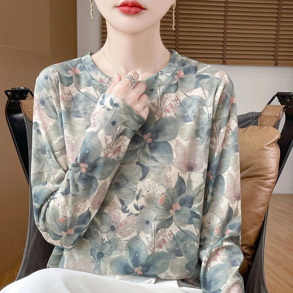 Round neck Tencel cotton pullover shirt with a colourful floral print, shown on a hanger.