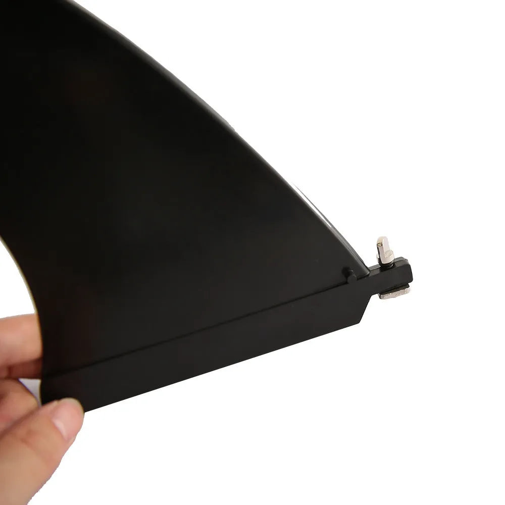 SUP paddle with a removable fish fin attached via a screw mechanism.