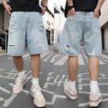 Light blue distressed denim shorts with ripped detailing and straight cut design on mannequin