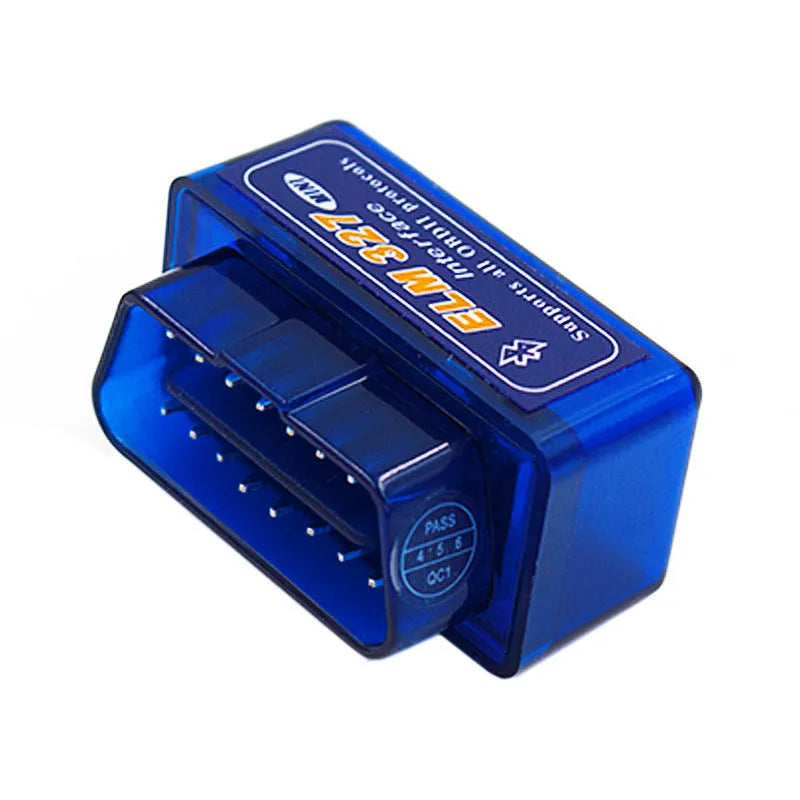 Small black Bluetooth OBD2 car diagnostic scanner next to a vehicle's diagnostic port