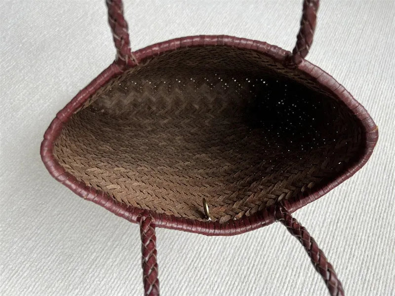 Brown handmade woven cowhide leather tote bag with a three-dimensional front pocket.