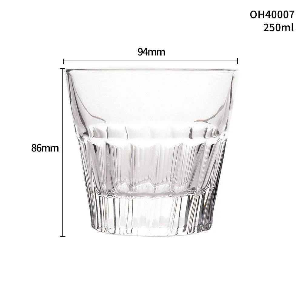A thick-bottomed crystal whiskey shot glass on a table, shown in one of the available colour options.