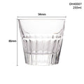 A thick-bottomed crystal whiskey shot glass on a table, shown in one of the available colour options.