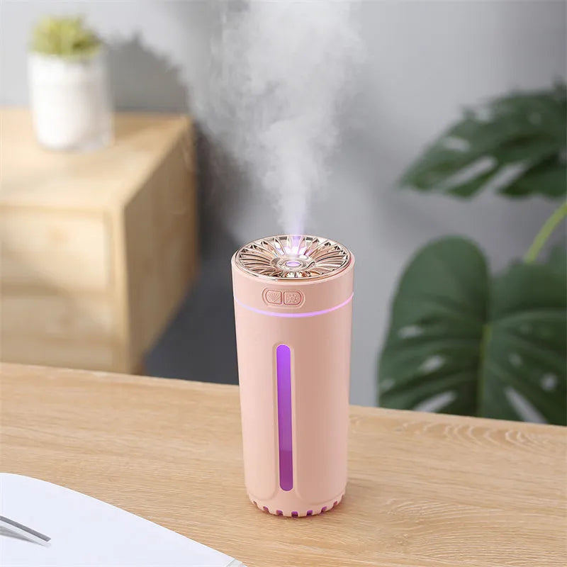 Black portable USB humidifier with colourful lights on a car cup holder.