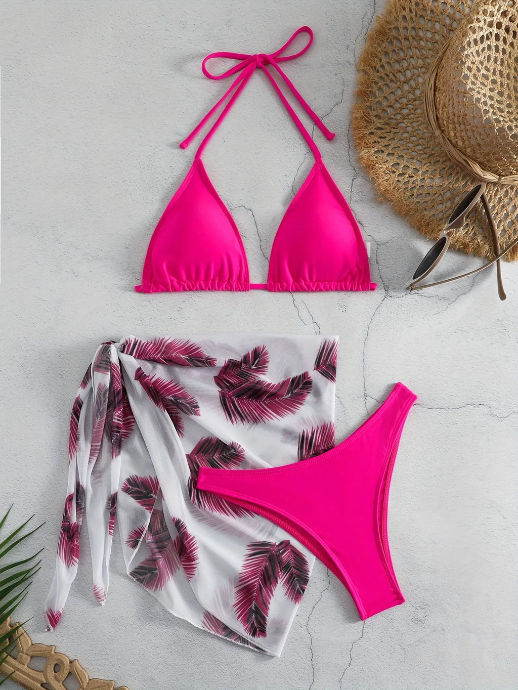 Women's orange three-piece bikini swimsuit set with a matching gauze skirt on a mannequin
