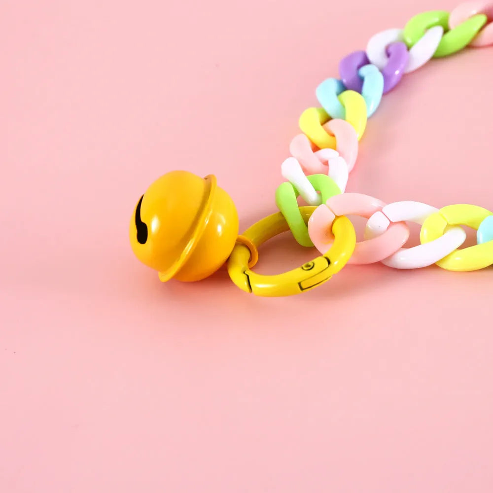 A plastic pet collar in macaron candy colours shown in blue, pink, and mixed variants, with a chain design and S/M size tags.