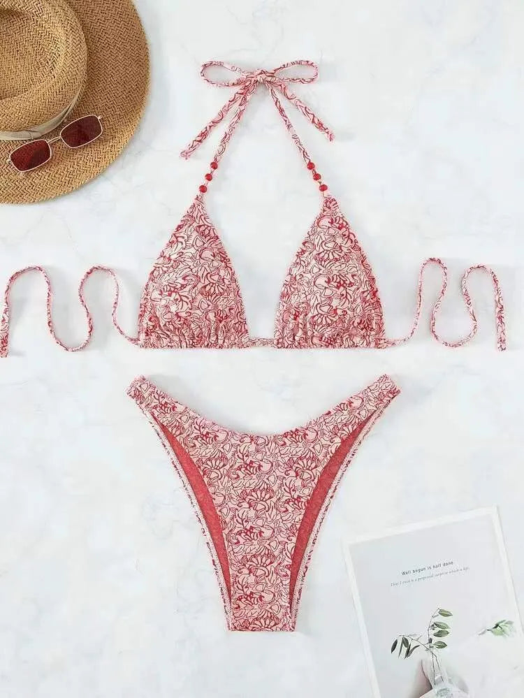 Women's red floral bikini halter swimsuit with lanyard top and shorts on a mannequin.