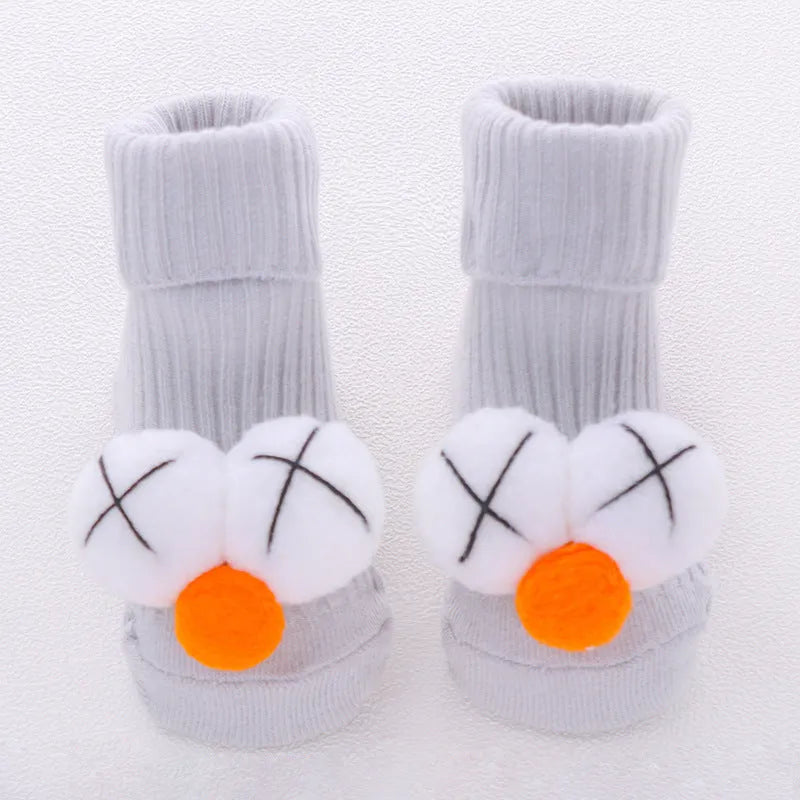 Cotton baby floor socks in a pink bow pattern, shown on an infant's feet.
