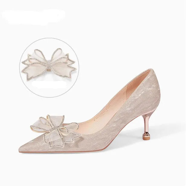 Champagne coloured sequinned pointed toe stiletto high heel pump on a white background.