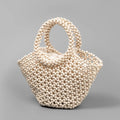 Hand-woven dumpling-shaped beach bag with wooden beads in milky white.