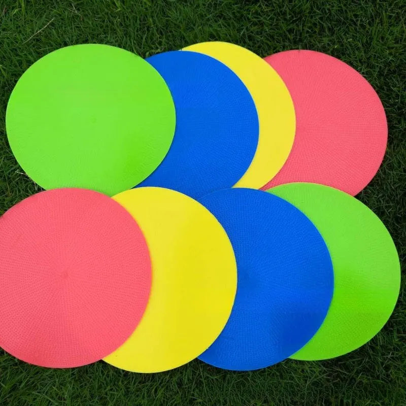 Multi-colour 23 cm diameter soft TPE football training target disc on grass
