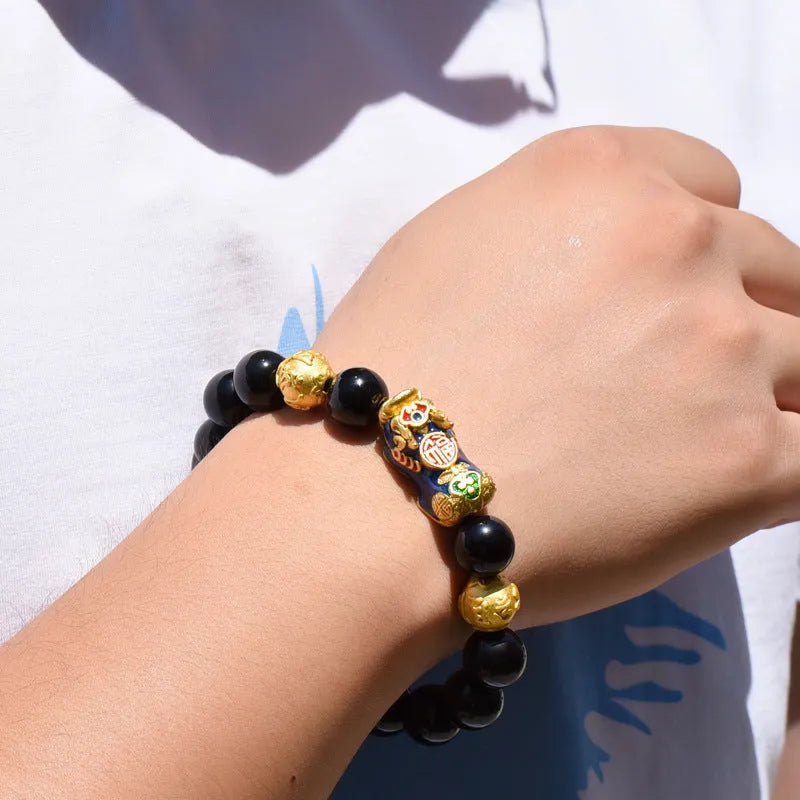 Natural obsidian temperature-sensitive colour change bracelet with gold accents and Pi Xiu motif