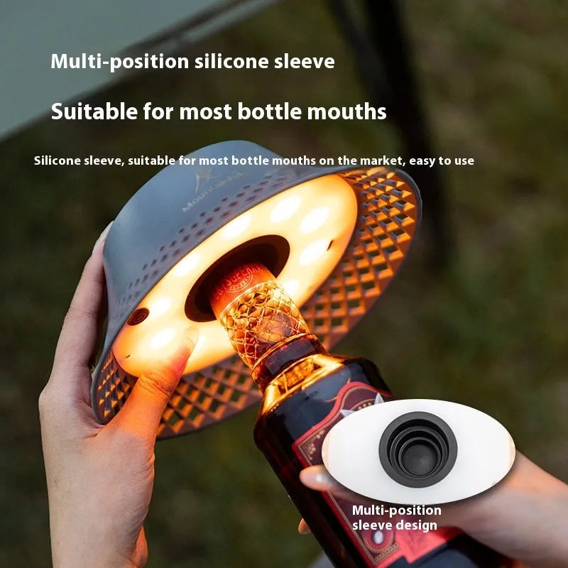 Beige and grey wine bottle shaped USB-C rechargeable camping lantern with three light modes.