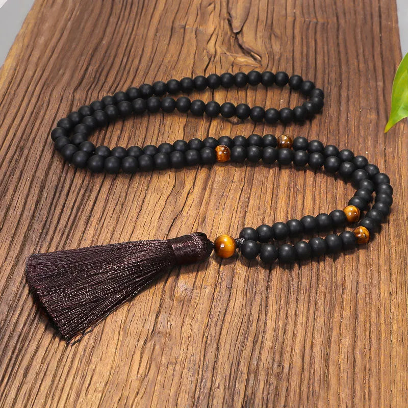Tiger eye stone beaded necklace and bracelet set with tassel pendants on white background