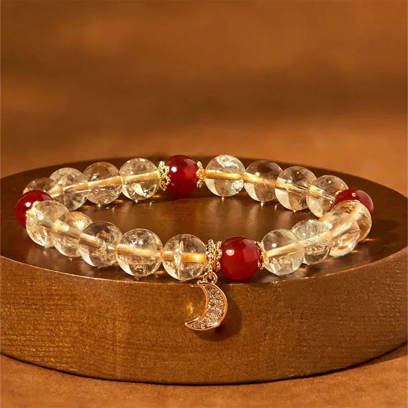 Citrine and red agate crystal moon boom bracelet for women on a white background.