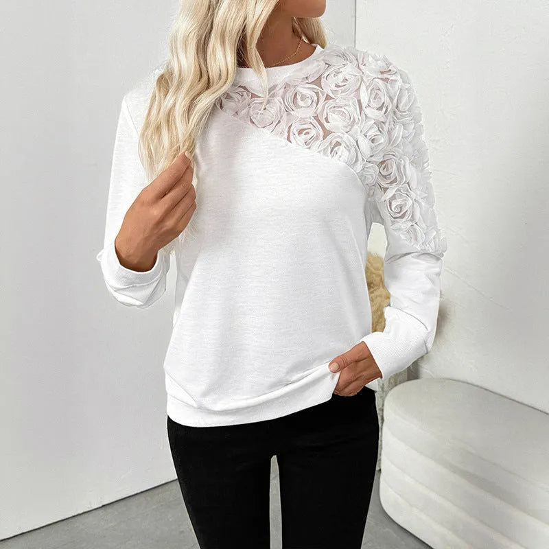 White long sleeve women's top with floral pattern, loose fit.