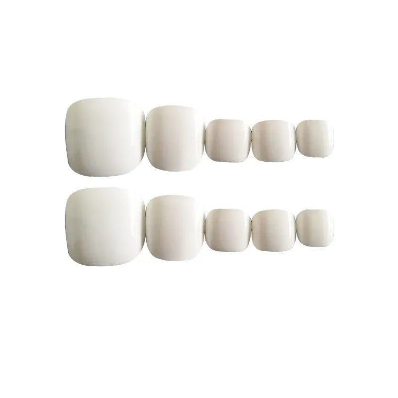 Set of white press-on fake nails with a starry sky pattern, laid out for display.