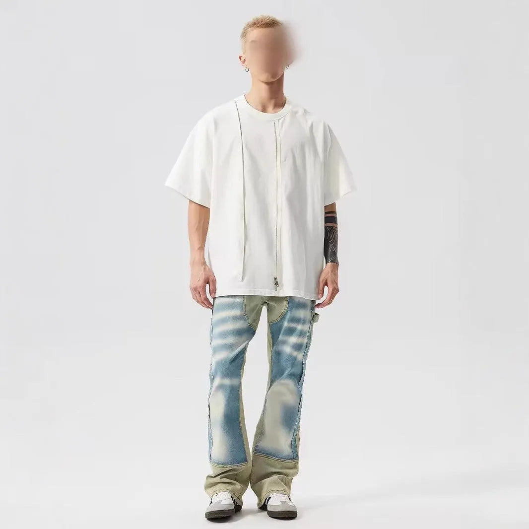 Yellow and blue retro patchwork jeans with splash-ink damaged design and zip fly.