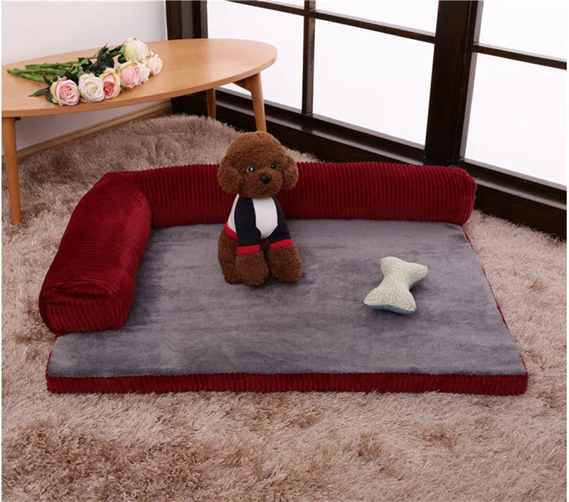 A corduroy pet sofa dog bed with bolsters, shown in a grey colour, placed on a hardwood floor.