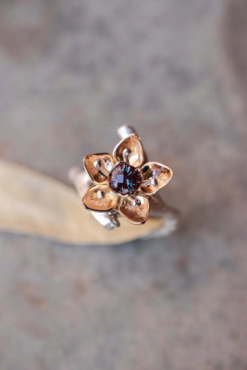 Silver two-tone geometric floral fashion ring for women on a hand.
