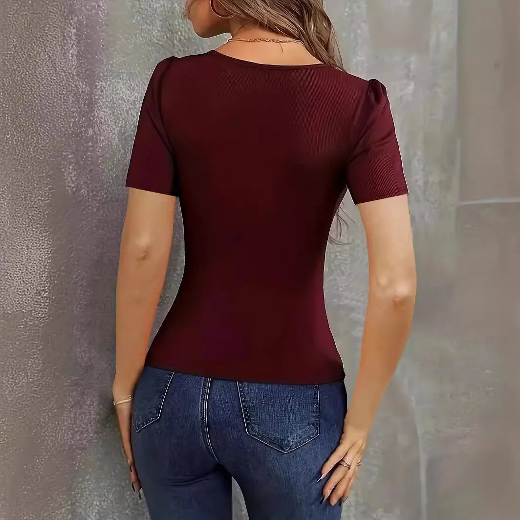 Women's wine red knitted slim fit short sleeve top with a low neckline on a hanger.