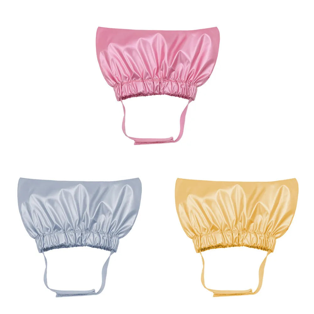 Silver adjustable pet shower cap for dogs and cats on a non-woven fabric background.