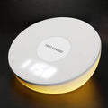 White wireless charging pad with digital clock display and control buttons for smartphone charging