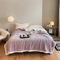 Taffeta thermal flannel winter blanket in beige draped over a modern sofa.