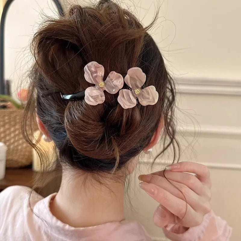 Retro flower petal bobby pin hair accessory in acrylic, shown on a background.