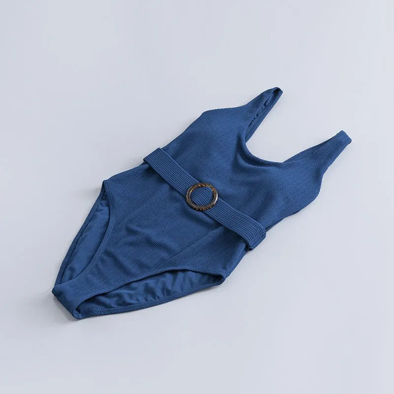 Navy blue women's slim-fit one-piece swimsuit with triangle top and removable padding.