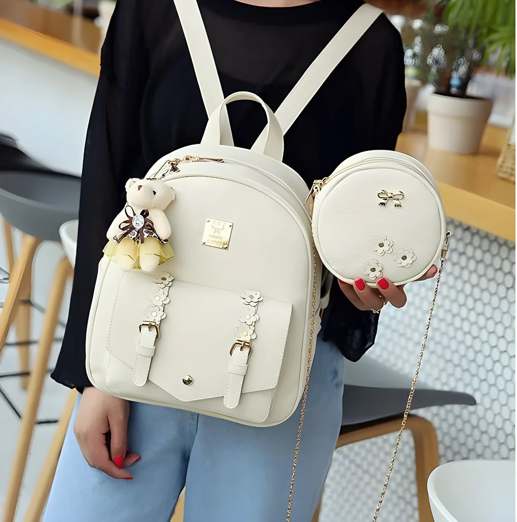 Women's three-piece leather bag set showing backpack, shoulder bag, and card holder with floral patterns