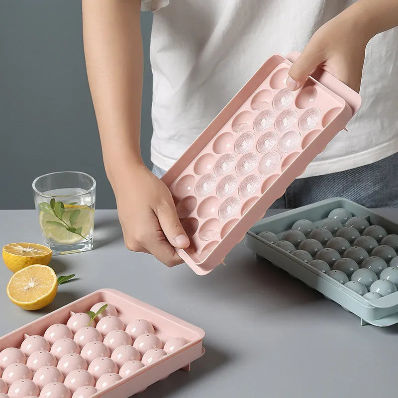 Sky blue and pink 3D round ice cube moulds with spherical cavities