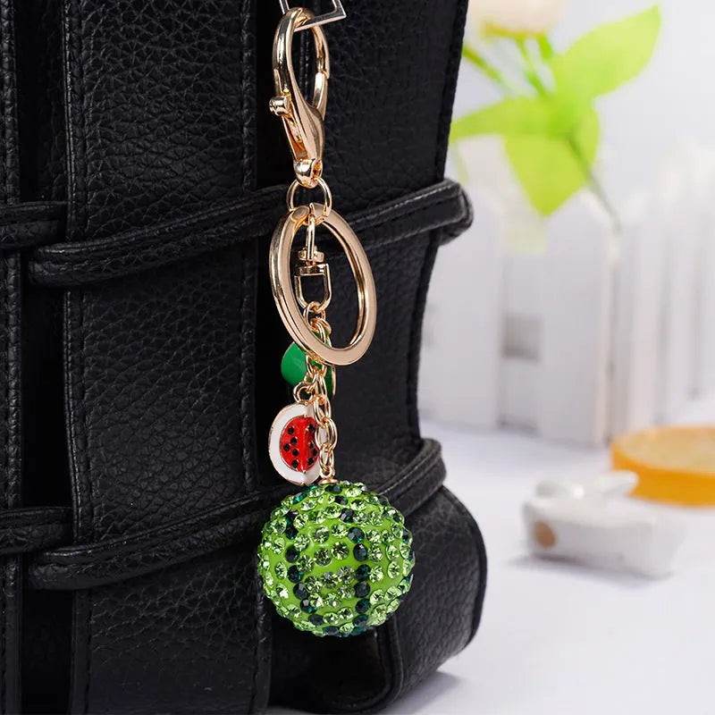 Green zinc alloy watermelon-shaped keychain measuring 12cm.