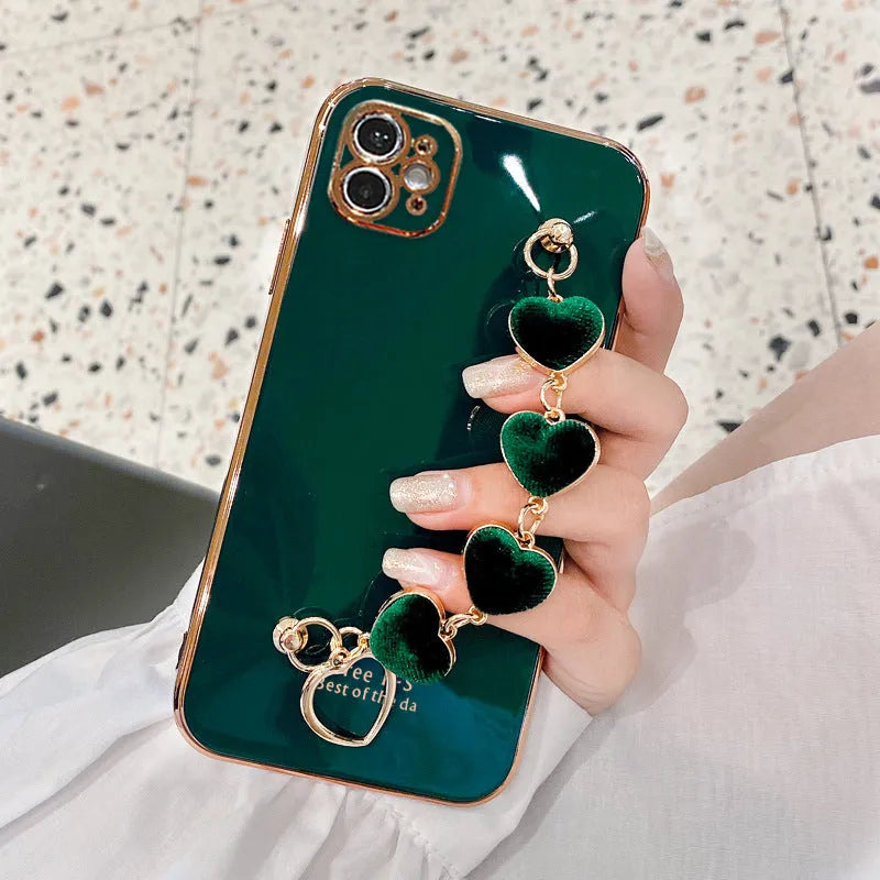 Green silicone Samsung phone case with an integrated fabric bracelet loop on the back.