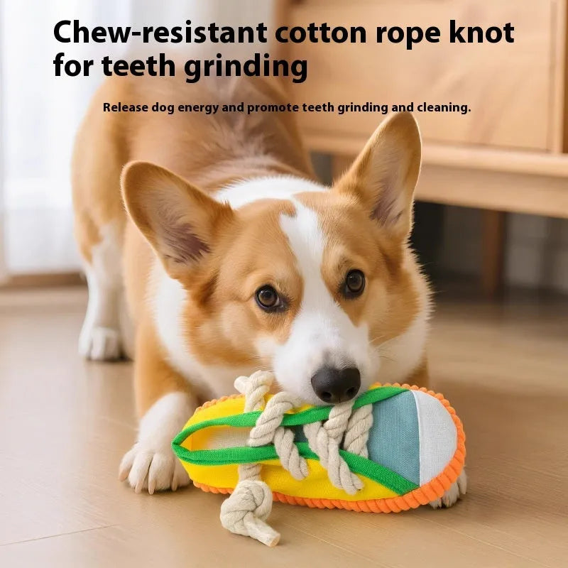 A rock yellow plastic dog chew toy shaped like a slipper, designed for biting and making sound.