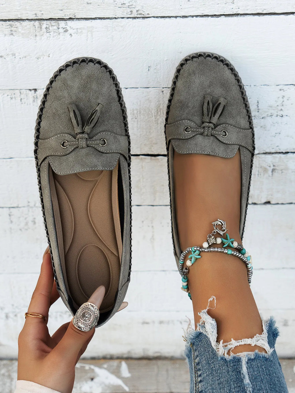 Women's solid colour suede flat shoes with a bow, shown in pink, apricot, grey, and blue on a casual background.