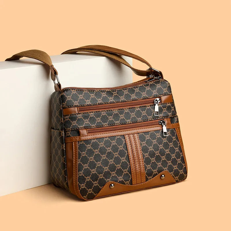 Brown stitching pattern women's crossbody bag made from PU leather with an adjustable strap.