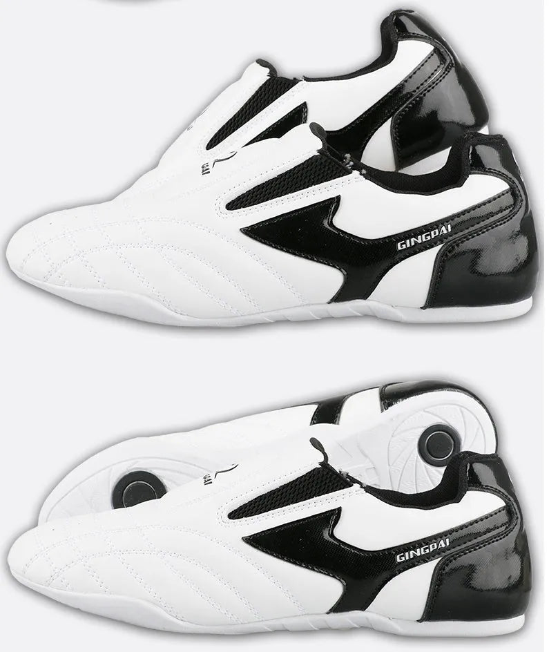 Black and white children's Sanda Taekwondo martial arts shoes with a soft sole and widened fit.