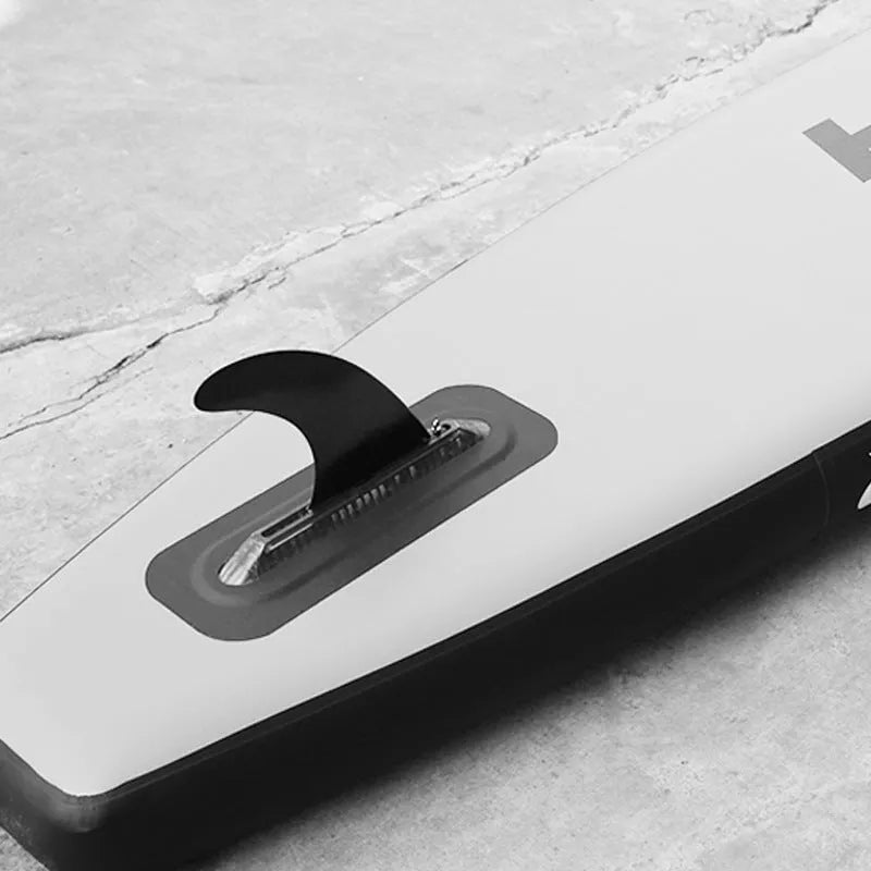 SUP paddle with a removable fish fin attached via a screw mechanism.