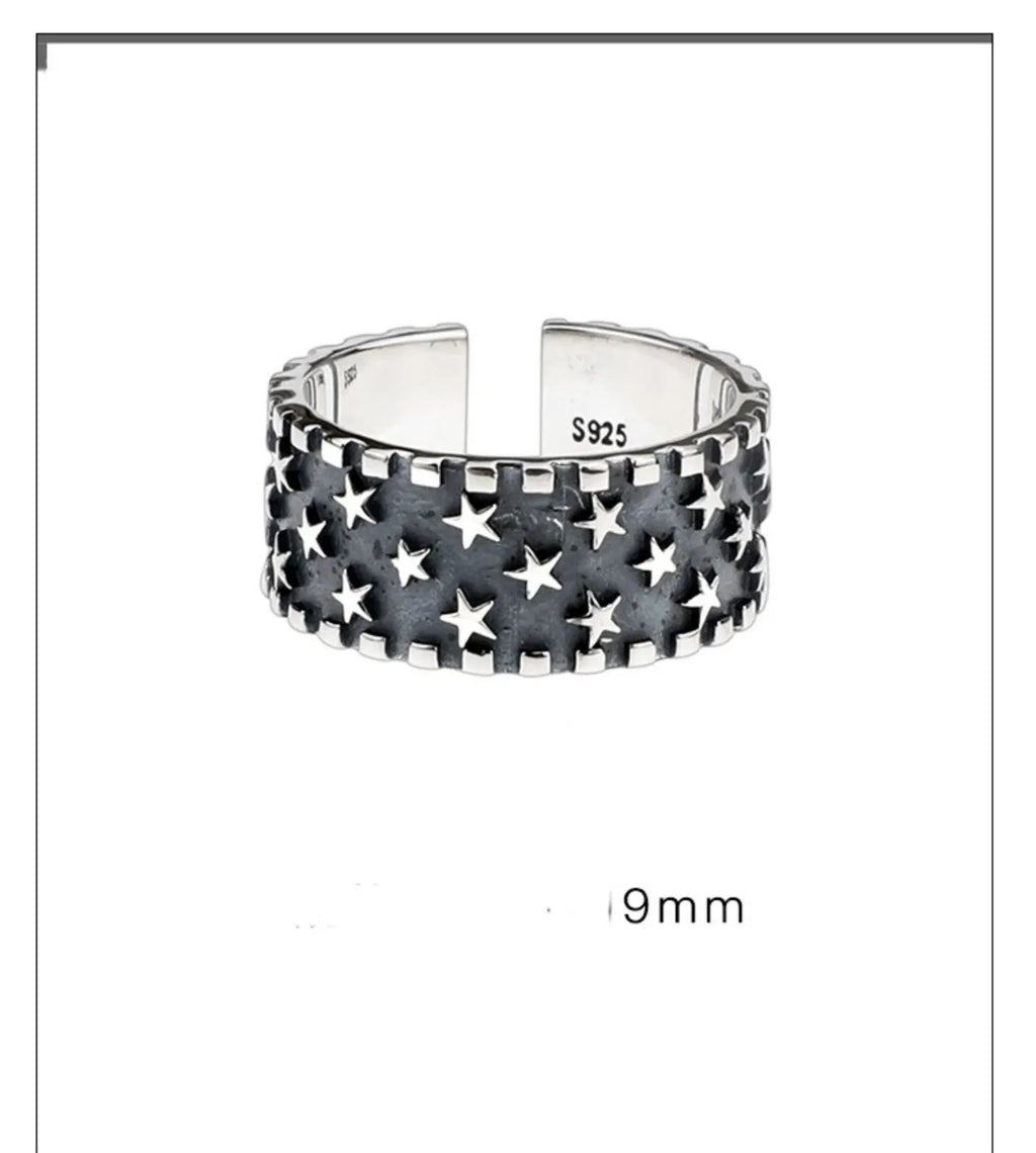 Adjustable silver ring with a geometric pattern of multiple five-pointed stars on the band.