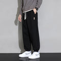 Men's loose fit casual sports trousers in gray, black, or army green with drawstring waist